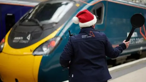 Avanti West Coast A picture of a train conductor wearing a Santa hat 