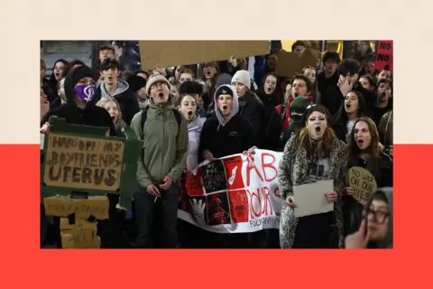 Sean Hansford/Manchester Evening News Protesters stand in the street, holding placards.
NOTE: this image is payable per use and should NOT be cloned.