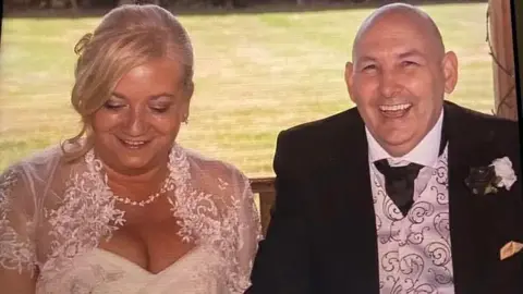 Supplied A photo of a wedding couple, the man is mid-laughter