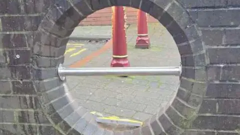 Spotted Ilkeston Town A metal bar in the middle of a hole in a wall