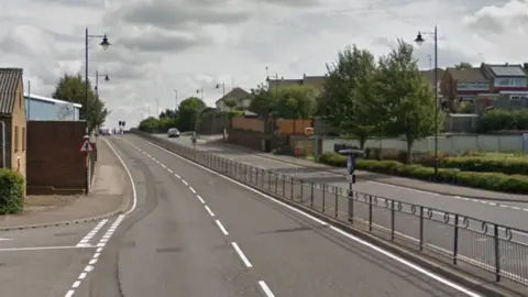 Google A Google Street image of a dual carriageway with a small fence in the middle.