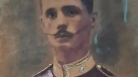 A portrait showing a man with dark hair and a moustache in uniform.