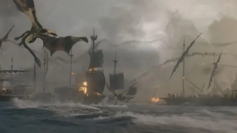 Courtesy of HBO Scene from House of the Dragon 3 with dragon flying over the sea and sailboats with tall masts on fire in stormy water