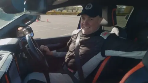 GWR A man smiles while driving a pick up