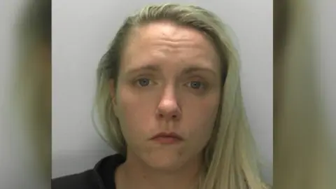 Police mugshot of Chelsea Iles, a woman in her late 20s with long blonde hair, parted at the side.