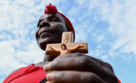 ABUBAKER LUBOWA/RETUERS A Catholic devotee attends the re-enactment of the crucifixion of Jesus Christ on Good Friday, 29 March.