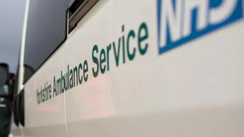 Yorkshire Ambulance Service and NHS logo on white vehicle