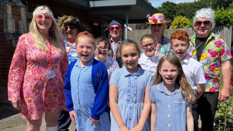Children of Filby Primary School with members of Filby in Bloom dressed in 1960s clothes