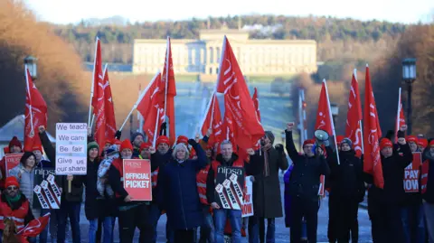 People on strike gather at Stormont