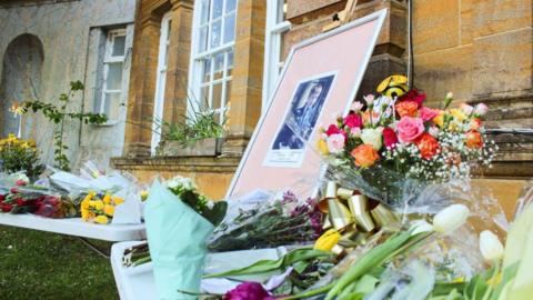 Flowers laid in front of school in memory of student