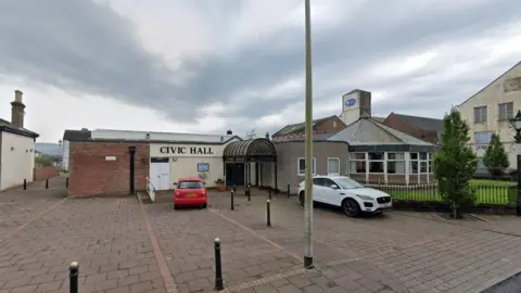 Google Cleator Moor Civic Hall and Masonic Centre. There are two cars parked outside.