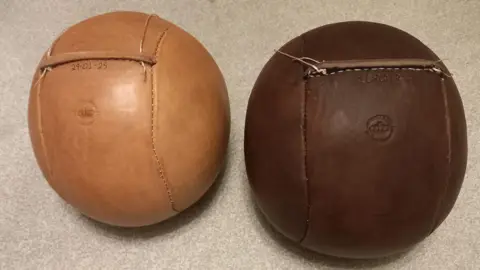 Carl Spencer Two leather balls that have been created for the Royal Shrovetide Football game