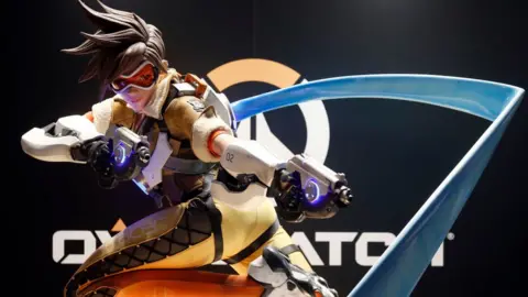 Getty Images A statue of the Tracer character frozen in mid-sprint with guns pointed