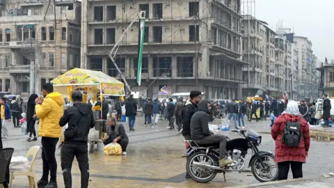 People gather around Aleppo Square.