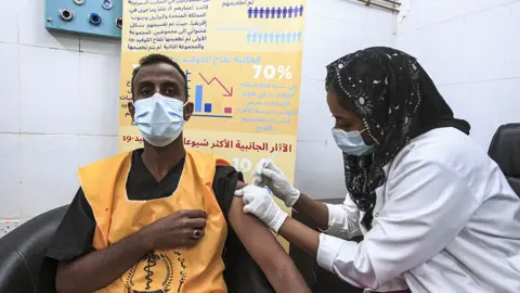 Getty Images A man is vaccinated in Sudan against Covid