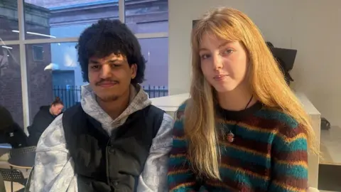 A brown haired young man and blonde haired woman