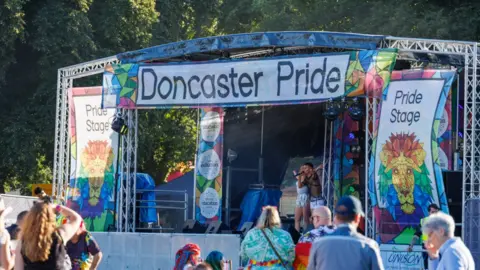 Doncaster Pride/Wayne Sables Outdoor music stage with Doncaster Pride banner across the top