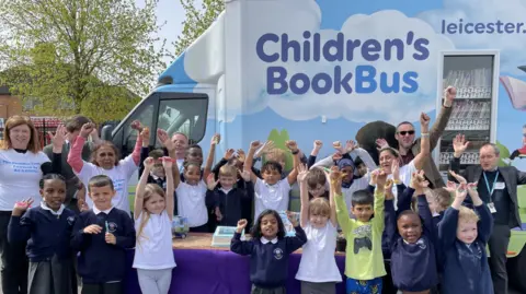 BBC Children from Braunstone Community Primary School standing outside the new book bus 