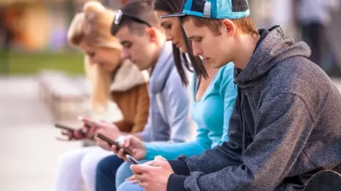 Getty Images young people on phone