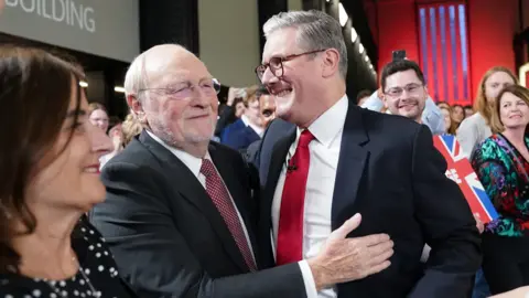 PA Media Labour leader Sir Keir Starmer is greeted by Neil Kinnock at the Tate Modern, central London, for a watch party for the results of the 2024 General Election.