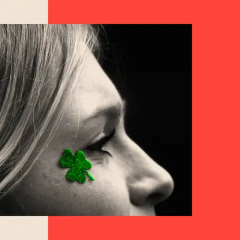 BBC A treated image shows a woman in profile with a clover sticker on her face.