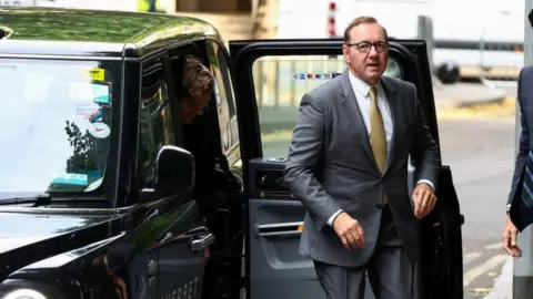 Reuters Kevin Spacey getting out of a taxi outside court