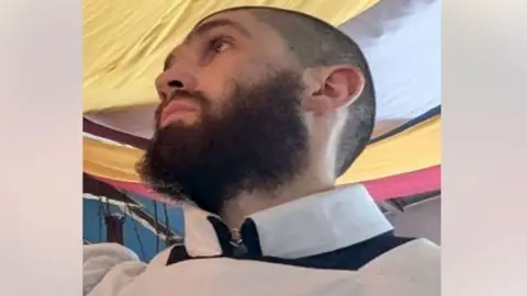 Justin Evans, a man with a black beard.