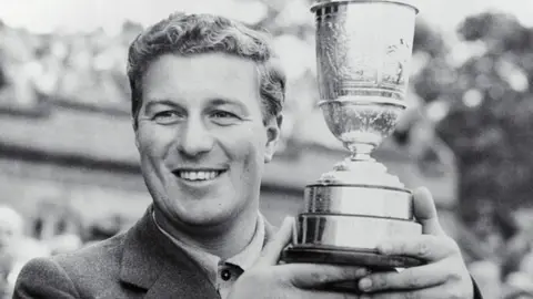 Getty Images Peter Thomson holds his third Open Championship trophy in 1956