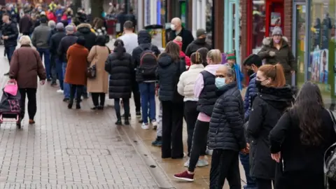 PA Media Hundreds of people queue at a vaccination centre on Solihull High Street, West Midlands
