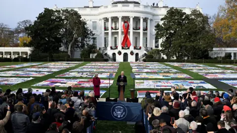 Reuters An image of former U.S. President Joe Biden giving a speech at an event marking World AIDS Day with the US AIDS Memorial Quilt on display for the first time on the South Lawn of the White House in Washington, on 1 December 2024.