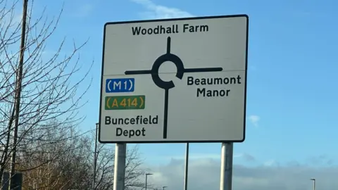 Eric Johnson/BBC A view of a roundabout sign where "Buncefield depot" can be clearly seen