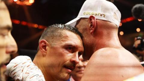 Oleksandr Usyk is hugged by Tyson Fury in the ring