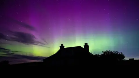 Mrs Brown/BBC Weather Watchers Aurora borealis and silhouette of a house in Orkney