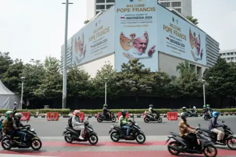 Getty Images A welcome message for Pope Francis is displayed on an electric billboard at a roundabout in Jakarta