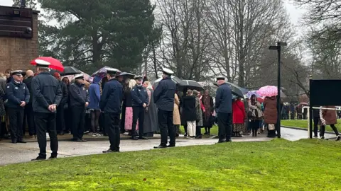 Withernsea RNLI and lifeboat crew forming a guard of honour. 