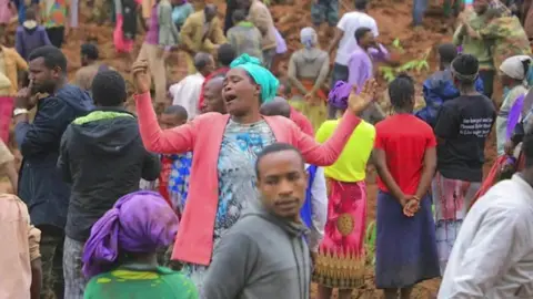 Reuters A crowd gathers at the scene of a landslide in Ethiopia