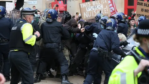 PA Media Police and the front line of protestors clashing