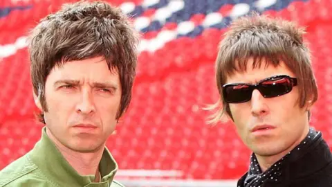 Getty Images Noel and Liam Gallagher at a football ground
