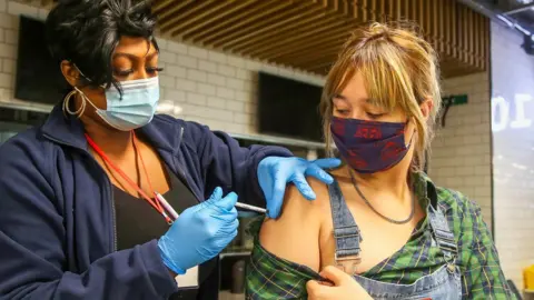 Getty Images Young woman is vaccinated