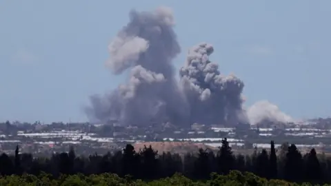 Reuters Smoke rises over the Gaza Strip, amid continued fighting between Israel and Hamas, as seen from southern Israel (6 May 2024)