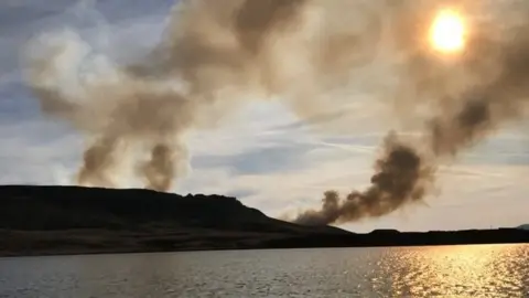 West Yorkshire Fire and Rescue Service Smoke rising above the reservoir