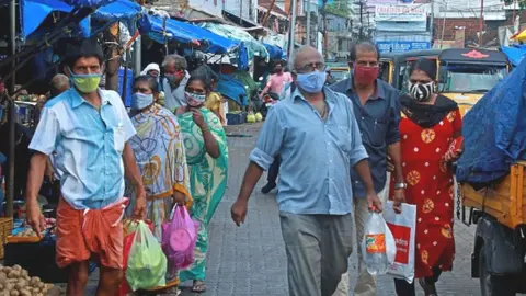 Getty Images People shop at a vegetable and fruit market amid Covid-19 coronavirus pandemic in Kochi on May 7, 2021