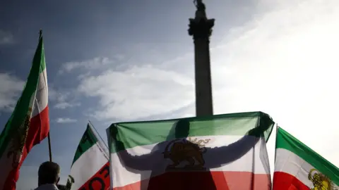 Reuters A man holds up a flag during the protest in London following the death of Mahsa Amini in Iran