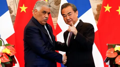 Reuters China's Foreign Minister Wang Yi (right) shakes hands with Dominican Republic's Chancellor Miguel Vargas