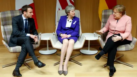 AFP Emmanuel Macron, Theresa May and Angela Merkel