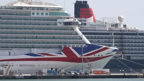 PA Media The P&O cruise ship Britannia (left) and the Cunard cruise ship Queen Victoria