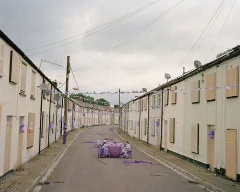 C Schneidermann/C James Children sat at table in street