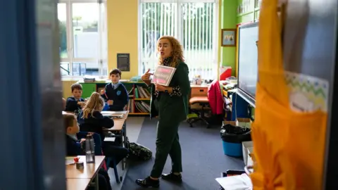 Karol McGonigle Michelle Furey teaching Irish to children in a classroom