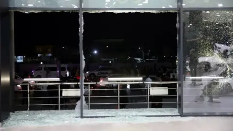 EPA Shattered glass at Irbil airport, Iraq. Photo: 15 February 2021