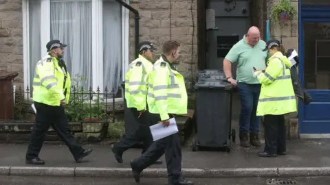 PA Media Emergency workers in Whaley Bridge